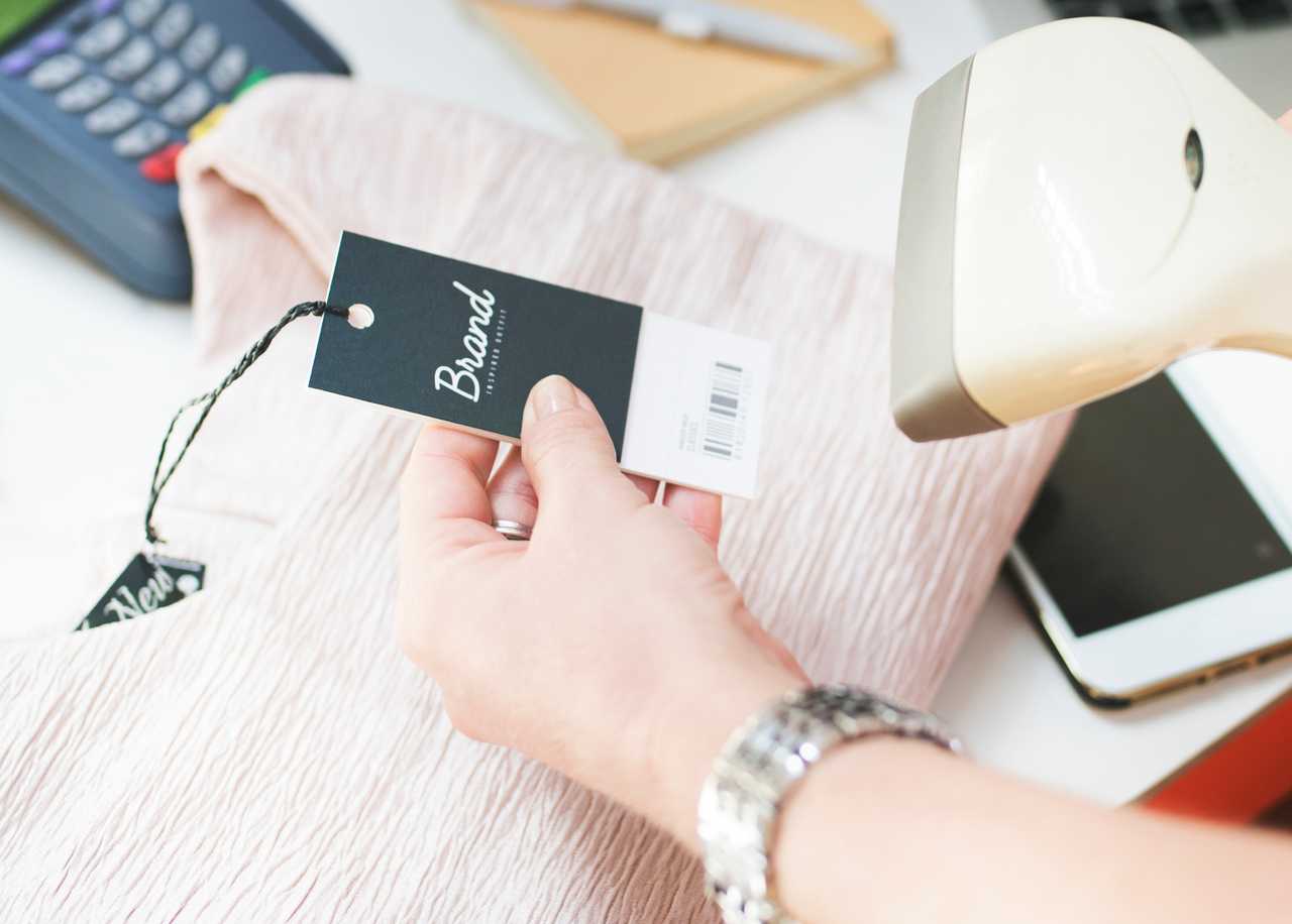 woman scanning barcode of a blouse at checkout