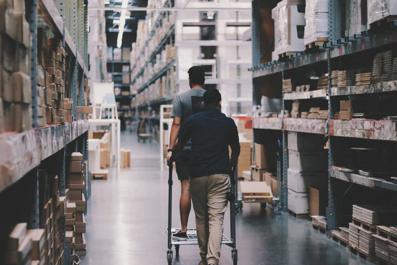Man walking in storage hall with shopping cart