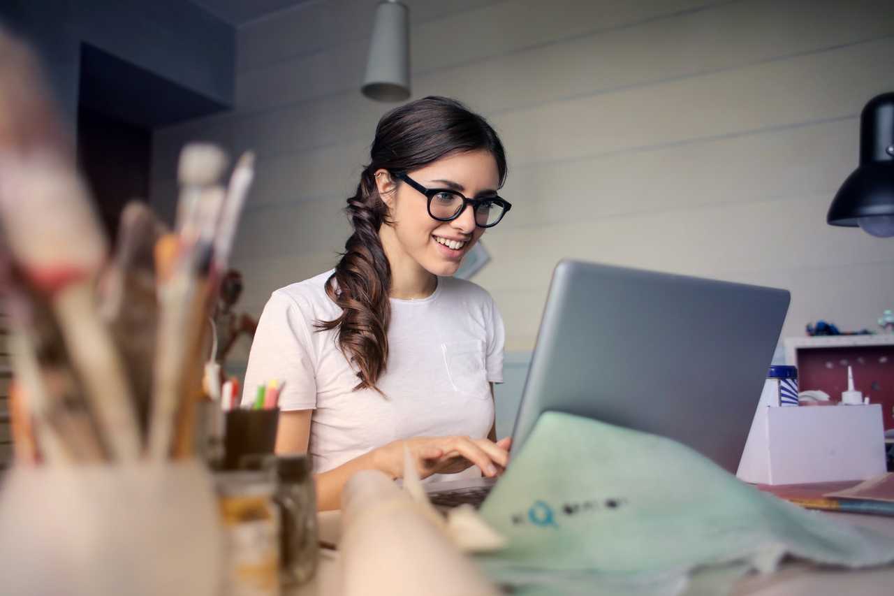 Happy woman in front of laptop