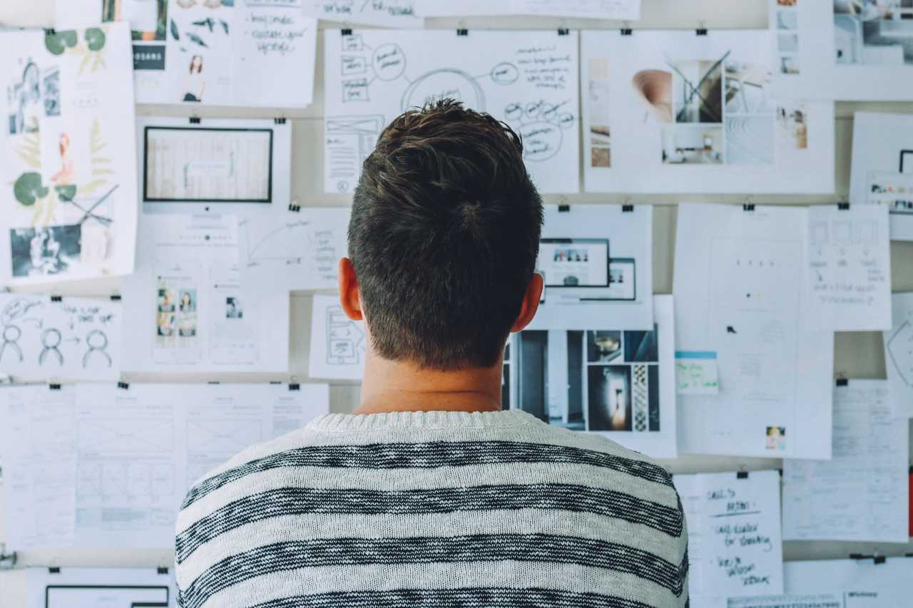 person looking at complex pin-board