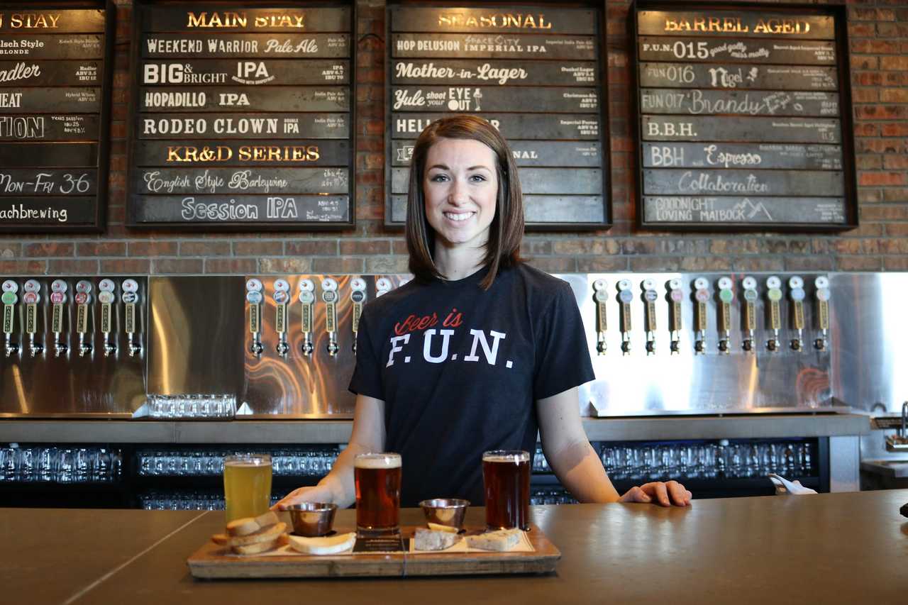 smiling bartender serving beer