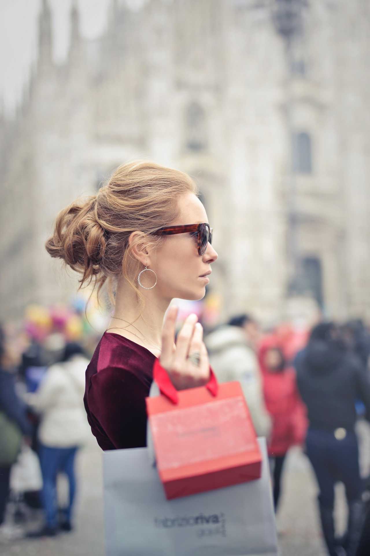 woman with shopping bag in busy plaza